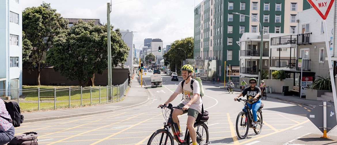 Two people riding bikes in Wellington on a bike tour.