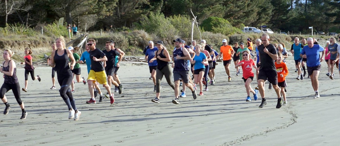 Competitors in the Waimea Harriers Wallace Shield Race Without Watches run along the beach at Rabbit Island.