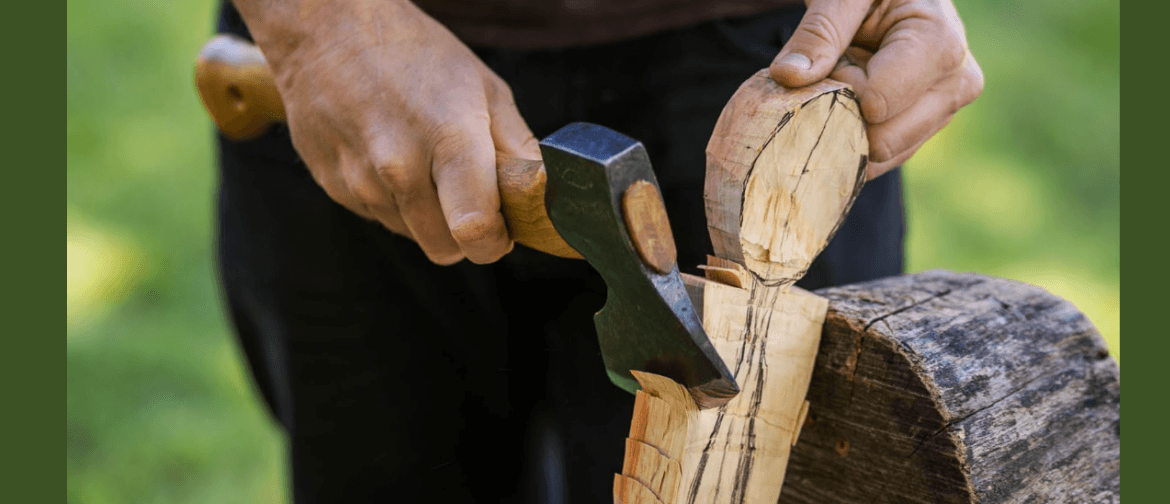 Complete Spoon Carving Workshop Image of an axe being held to chop the shape of a spoon