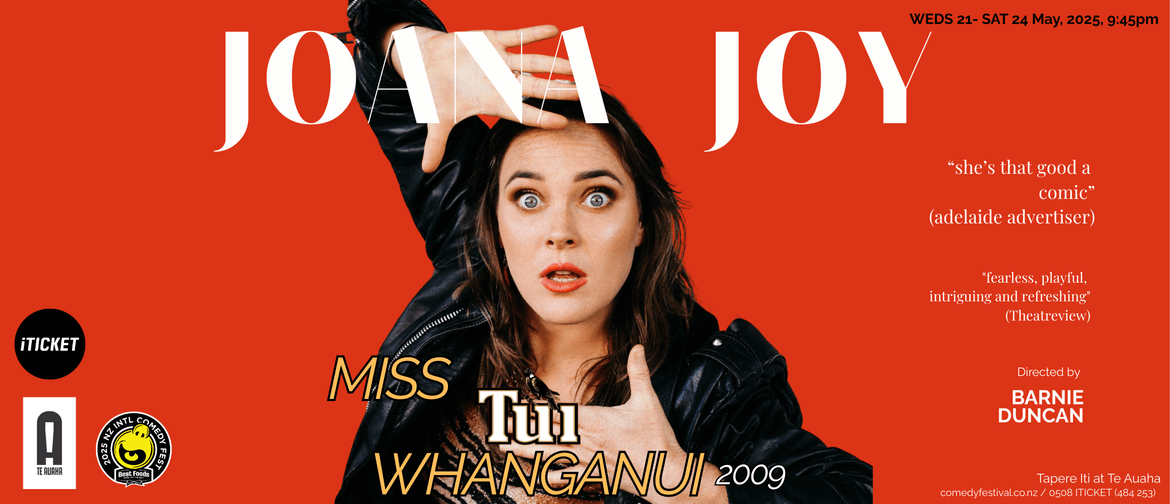 Picture of Joana Joy framing her hands around her face. She is wearing a leather jacket and tiger print top, bright orange lipstick on an orange background. Joana is a caucassian woman with brown hair and blue eyes